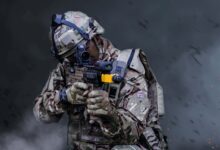 A British soldier holding a gun in ready combat position during training exercises