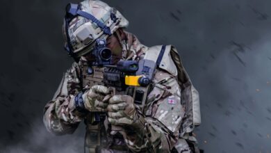 A British soldier holding a gun in ready combat position during training exercises