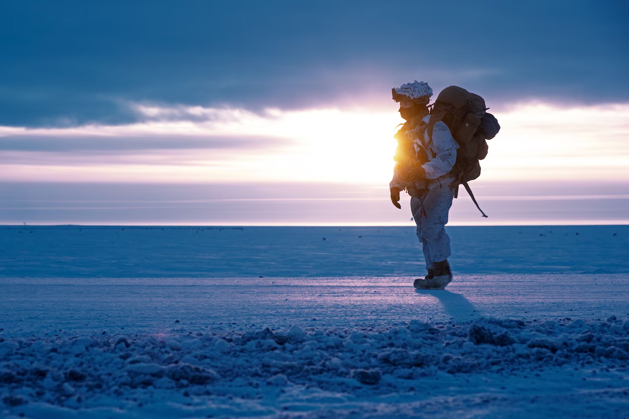 A soldier walks on frozen land near Utqiagvik, Alaska as part of Joint Pacific Multinational Readiness Training Center 24-02, February, 2024