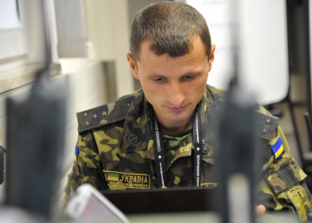 A member of the Ukraine military monitors and maintain network access during an exercise