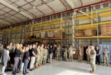 Soldiers, Airmen, U.S. and Italian civilian employees listen as U.S. Army Gen. Christopher Cavoli, commander, U.S. European Command & Supreme Allied Commander explains the importance of the new warehouse during an Oct. 9 event at Aviano Air Base. (Scavetta, Richard (Rick) A., CIV USARMY IMCOM EUROPE (US))