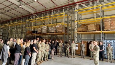 Soldiers, Airmen, U.S. and Italian civilian employees listen as U.S. Army Gen. Christopher Cavoli, commander, U.S. European Command & Supreme Allied Commander explains the importance of the new warehouse during an Oct. 9 event at Aviano Air Base. (Scavetta, Richard (Rick) A., CIV USARMY IMCOM EUROPE (US))