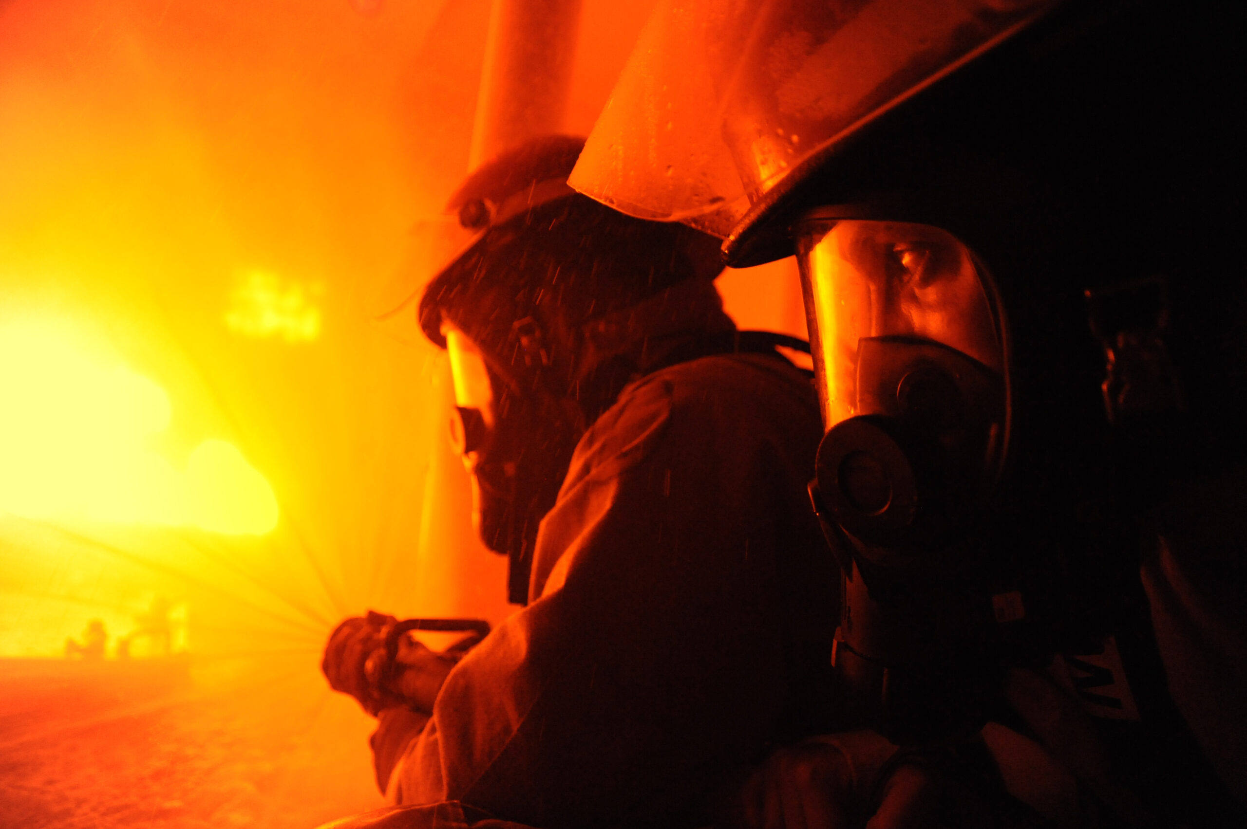 CAPE MAY, N.J. - Coast Guard recruits from Company Zulu 186 man a fire hose during firefighting training aboard Training Center Cape May Aug. 1, 2012.Shipboard fires are a enduring threat to any mariner, so every recruit learns the basics of shipboard firefighting prior to graduation. Coast Guard photo by Chief Warrant Officer Donnie Brzuska.