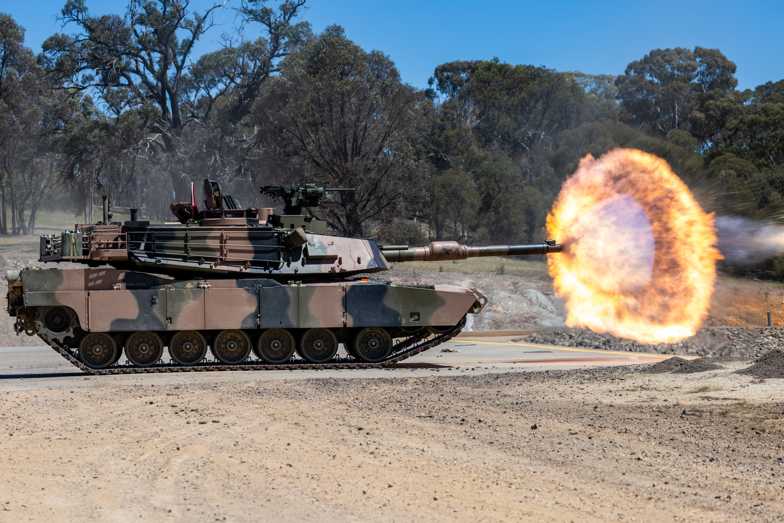 An Australian M1A2 SEP v3 Main Battle Tank fires a sabot round during a live fire to confirm the aiming system of the tank and to qualify crews on the new systems at the Puckapunyal Military Area, Victoria, 05 November 2024. *** Local Caption *** Armys combined arms fighting system will be modernised through the delivery of LAND 907. LAND 907 will deliver M1A2 Abrams System Enhancement Package version 3 (SEPv3) main battle tanks (MBTs). LAND 907 will also deliver the assault breacher vehicle (ABV) and joint assault bridge (JAB) collectively known as the combat engineering vehicles (CEV). The MBT and CEV are manufactured in the United States of America in Alabama, Ohio and Missouri before being shipped to Australia from the United States of America. The initial block of MBT, comprising 27 vehicles, departed the US in late June and arrived in Australia in August 2024. The initial block of CEV will also be shipped to Australia, arriving in 2025. In accordance with outcomes of the 2024 National Defence Strategy, the MBT and CEV will be located in Townsville as part of the 3rd Brigades 2nd Cavalry Regiment and 3rd Combat Engineer Regiment respectively, with small fleets located in Puckapunyal and Wodonga.