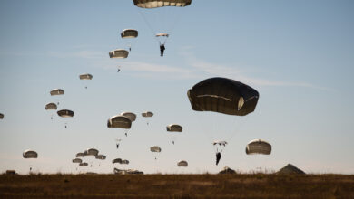 Paratroopers float to earth as part of the re-invigorated Saturday Proficiency Jump Program, Nov. 21, 2015, on Sicily Drop Zone. The once popular program was restarted in October to allow paratroopers to build additional proficiency and confidence for airborne operations. In November the program continued to build momentum with an additional 150 jumpers. Families and friends gathered on Sicily Drop Zone to watch the daytime spectacle and share in the unique U.S. Army paratrooper experience. (U.S. Army photo by Staff Sgt. Charles Crail, XVIII Airborne Corps/Released)