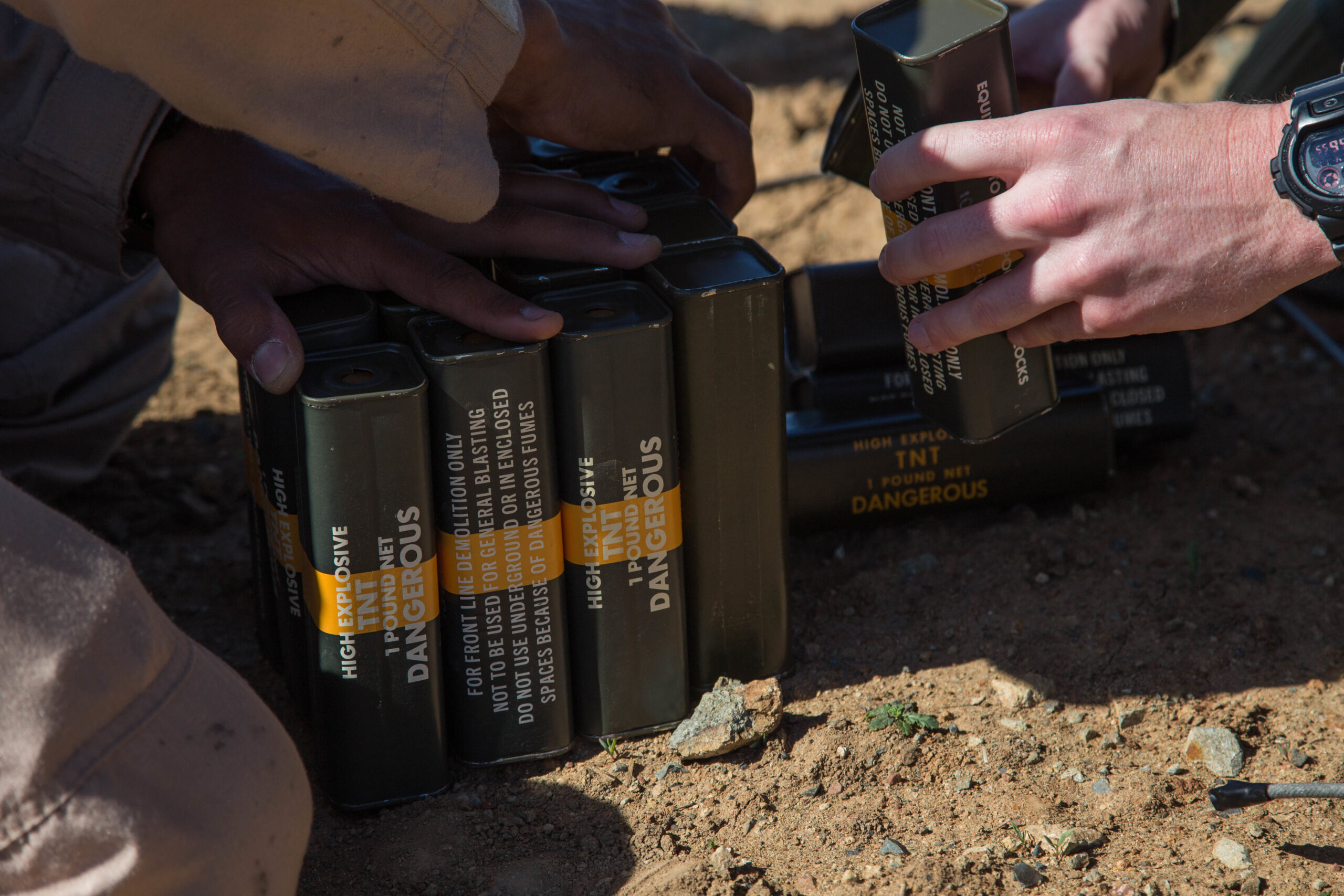 U.S. Marines with 1st Explosive Ordnance Disposal Company, 7th Engineer Support Battalion, 1st Marine Logistics Group, partner with Orange County Sheriff’s Department Hazardous Devices Section to set explosive charges during the Post-Blast Analysis Course at Camp Pendleton, Calif., April 11, 2018. The Marines and sheriffs prepare charges of trinitrotoluene (TNT) to be placed in the ground before detonation. (U.S. Marine Corps Photo by Lance Cpl. Quentarius Johnson)