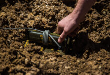 A U.S. Marine with 1st Explosive Ordnance Disposal Company, 7th Engineer Support Battalion, 1st Marine Logistics Group, places a charge of trinitrotoluene (TNT) in a muddy portion of the ground during the Post-Blast Analysis Course at Camp Pendleton, Calif., April 11, 2018. To show how terrain effects the outcome of craters explosive chargers are placed in different areas. This Includes dry packed dirt, loose dirt, and mud. (U.S. Marine Corps Photo by Lance Cpl. Quentarius Johnson)