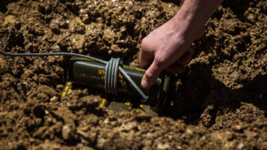 A U.S. Marine with 1st Explosive Ordnance Disposal Company, 7th Engineer Support Battalion, 1st Marine Logistics Group, places a charge of trinitrotoluene (TNT) in a muddy portion of the ground during the Post-Blast Analysis Course at Camp Pendleton, Calif., April 11, 2018. To show how terrain effects the outcome of craters explosive chargers are placed in different areas. This Includes dry packed dirt, loose dirt, and mud. (U.S. Marine Corps Photo by Lance Cpl. Quentarius Johnson)