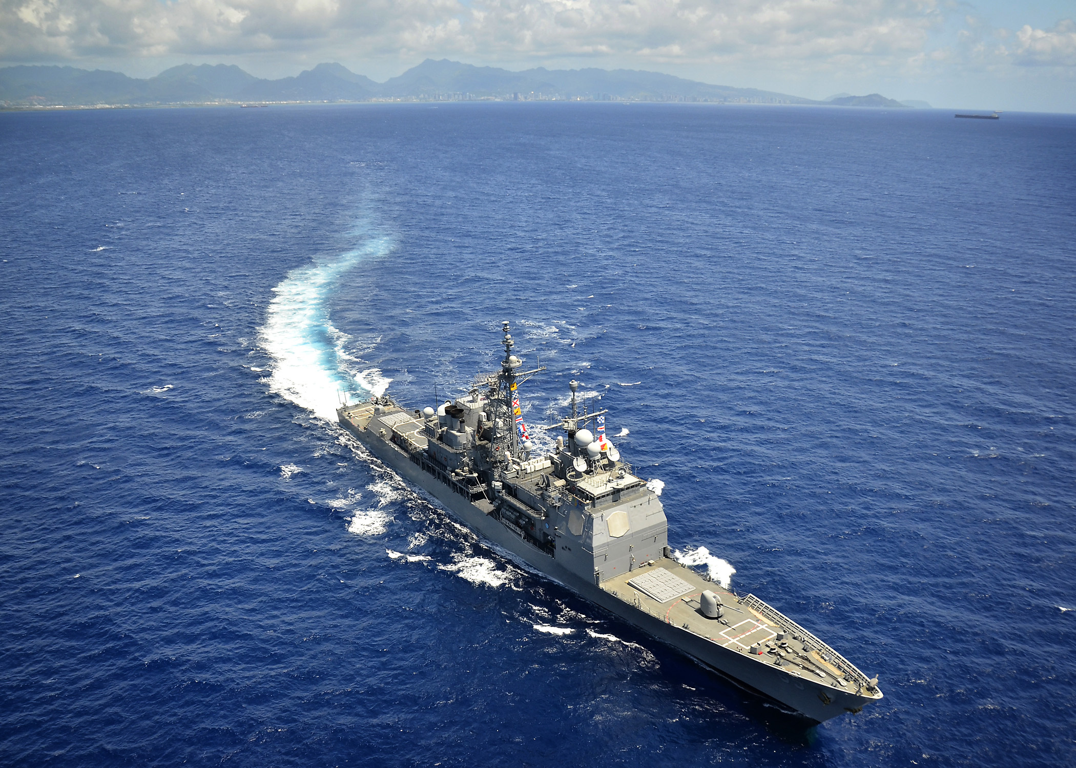 The Ticonderoga-class guided-missile cruiser USS Chosin (CG 65) conducts exercises off the coast of Hawaii following a departure from Joint Base Pearl Harbor-Hickam.