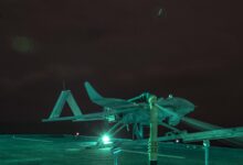 Aerosonde Unmanned Arial Surveillance (UAS) vehicle, Buck G, awaits to launch aboard the Expeditionary Sea-Base USS Hershel “Woody” Williams (ESB 4) in the Atlantic Ocean, Sept. 25, 2020. The UAS is piloted by Aerosonde personnel from the Hershel “Woody” Williams and provides live aerial surveillance to enhance the ship’s security. Hershel “Woody” Williams is on its inaugural deployment in the U.S. Naval Forces Europe-Africa area of responsibility in support of maritime missions and special operations. (U.S. Marine Corps photo by Sgt. Megan Roses/Released)