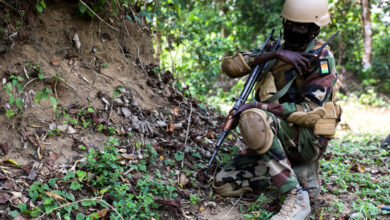 A Nigerien Special Forces Soldier communicates on a radio while conducting a raid during Flintlock 2022, in Côte d'Ivoire, Feb. 26, 2022. Flintlock is a multi-national exercise consisting of 11 nations training in Côte d'Ivoire. Flintlock helps strengthen the ability of allies and partners to counter violent extremism and provide security for their people. (U.S. Army photo by Sgt. Kacie Benak)