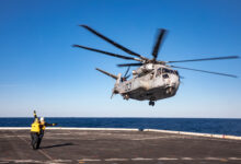 Aviation Boatswain’s Mate (Handling) Airman Victor Vazquez Ramos, assigned to the San Antonio-class amphibious transport dock ship USS Arlington (LPD 24), launches a Sikorsky CH-53K King Stallion helicopter from Arlington’s flight deck, Feb. 14, 2023. The King Stallion is a heavy-lift cargo helicopter undergoing sea trials as the next evolution of the CH-53 series helicopters that have been in service since 1966. (U.S. Navy photo by Mass Communication Specialist 1st Class John Bellino)