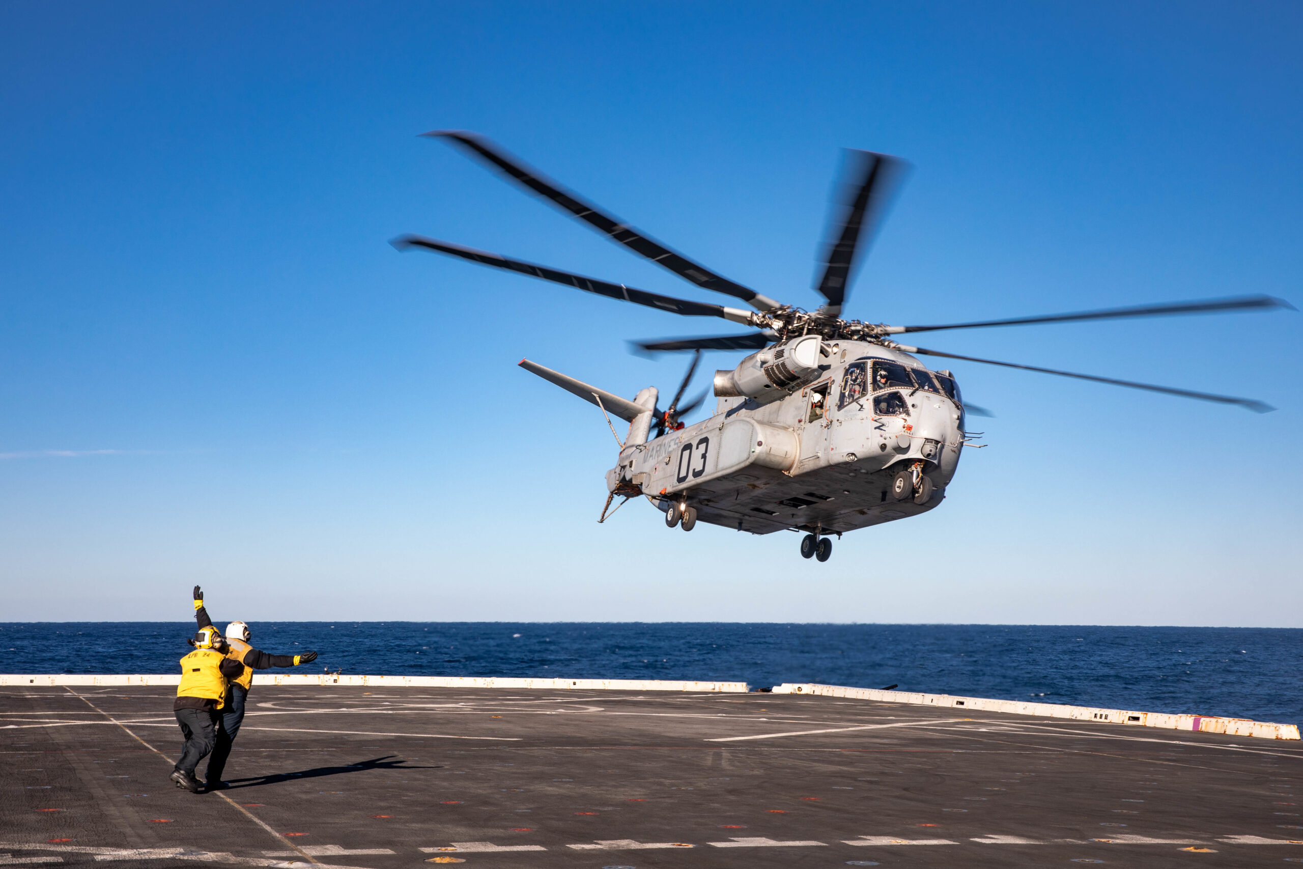 Aviation Boatswain’s Mate (Handling) Airman Victor Vazquez Ramos, assigned to the San Antonio-class amphibious transport dock ship USS Arlington (LPD 24), launches a Sikorsky CH-53K King Stallion helicopter from Arlington’s flight deck, Feb. 14, 2023. The King Stallion is a heavy-lift cargo helicopter undergoing sea trials as the next evolution of the CH-53 series helicopters that have been in service since 1966. (U.S. Navy photo by Mass Communication Specialist 1st Class John Bellino)