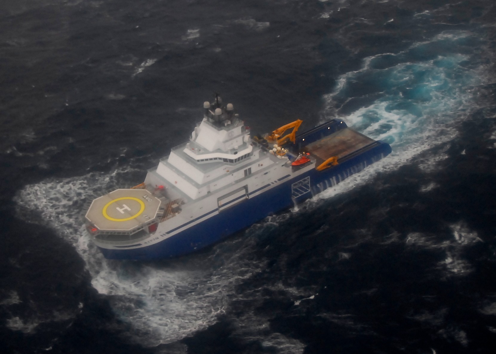 The tow supply vessel Aiviq travels just under 2 mph with Royal Dutch Shell's conical drilling unit Kulluk in tow 116 miles southwest of Kodiak City, Alaska, Dec. 30, 2012. The Aiviq towed the Kulluk in tandem with the tug Nanuq. (U.S. Coast Guard photo by Petty Officer 2nd Class Chris Usher/Released)