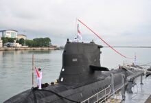 The decommissioning pennant of RSS Chieftain being lowered.