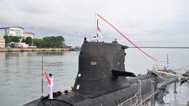 The decommissioning pennant of RSS Chieftain being lowered.