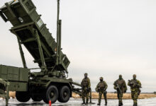 Swedish soldiers alongside a Patriot air defense system.