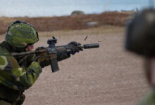 Soldier firing a Sako Automatkarbin 24 (AK 24) assault rifle