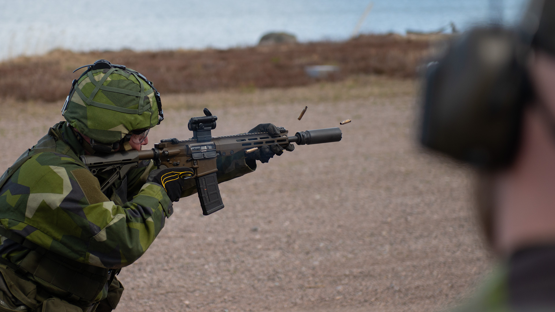 Soldier firing a Sako Automatkarbin 24 (AK 24) assault rifle 