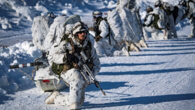 Troops in formation at an icy environment.