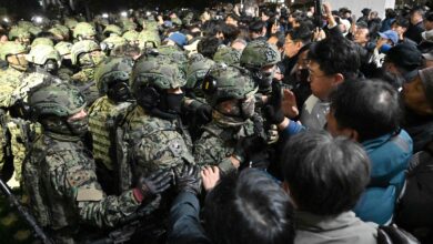 Soldiers try to enter the National Assembly building in Seoul on December 4 2024, after South Korea President Yoon Suk Yeol declared martial law. South Korea's President Yoon Suk Yeol on December 3 declared martial law, accusing the opposition of being "anti-state forces" and saying he was acting to protect the country from "threats" posed by the North. (Photo by Jung Yeon-je / AFP)