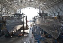 Hulls of two future Evolved Cape-class patrol boats under construction in a shipyard