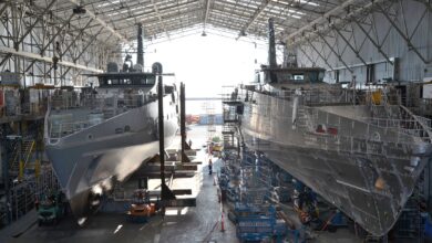 Hulls of two future Evolved Cape-class patrol boats under construction in a shipyard