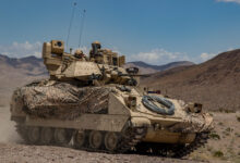 Soldiers from 1st Battalion, 163rd Cavalry Regiment, Montana Army National Guard, push on in their Bradley Fighting Vehicle during a defensive attack training exercise at the National Training Center (NTC) in Fort Irwin, Calif., June 1, 2019. A month-long NTC Rotation provides more than 4,000 service members from 31 states, including units from 13 National Guard states and territories, with realistic training to enhance their combat, support and sustainment capabilities. (Photo by: Cpl. Alisha Grezlik, 115th Mobile Public Affairs Detachment)