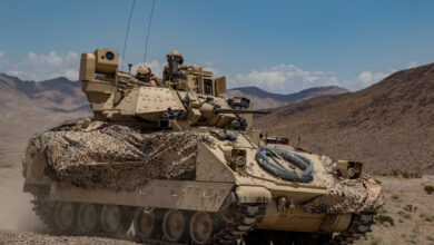 Soldiers from 1st Battalion, 163rd Cavalry Regiment, Montana Army National Guard, push on in their Bradley Fighting Vehicle during a defensive attack training exercise at the National Training Center (NTC) in Fort Irwin, Calif., June 1, 2019. A month-long NTC Rotation provides more than 4,000 service members from 31 states, including units from 13 National Guard states and territories, with realistic training to enhance their combat, support and sustainment capabilities. (Photo by: Cpl. Alisha Grezlik, 115th Mobile Public Affairs Detachment)