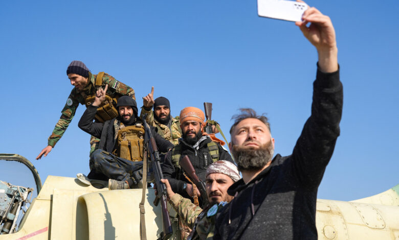 Anti-government fighters pose for a "selfie" picture on a Syrian regime military aircraft at the Kweyris military airfield in the eastern part of Aleppo province on December 3, 2024. (Rami al Sayed/AFP)