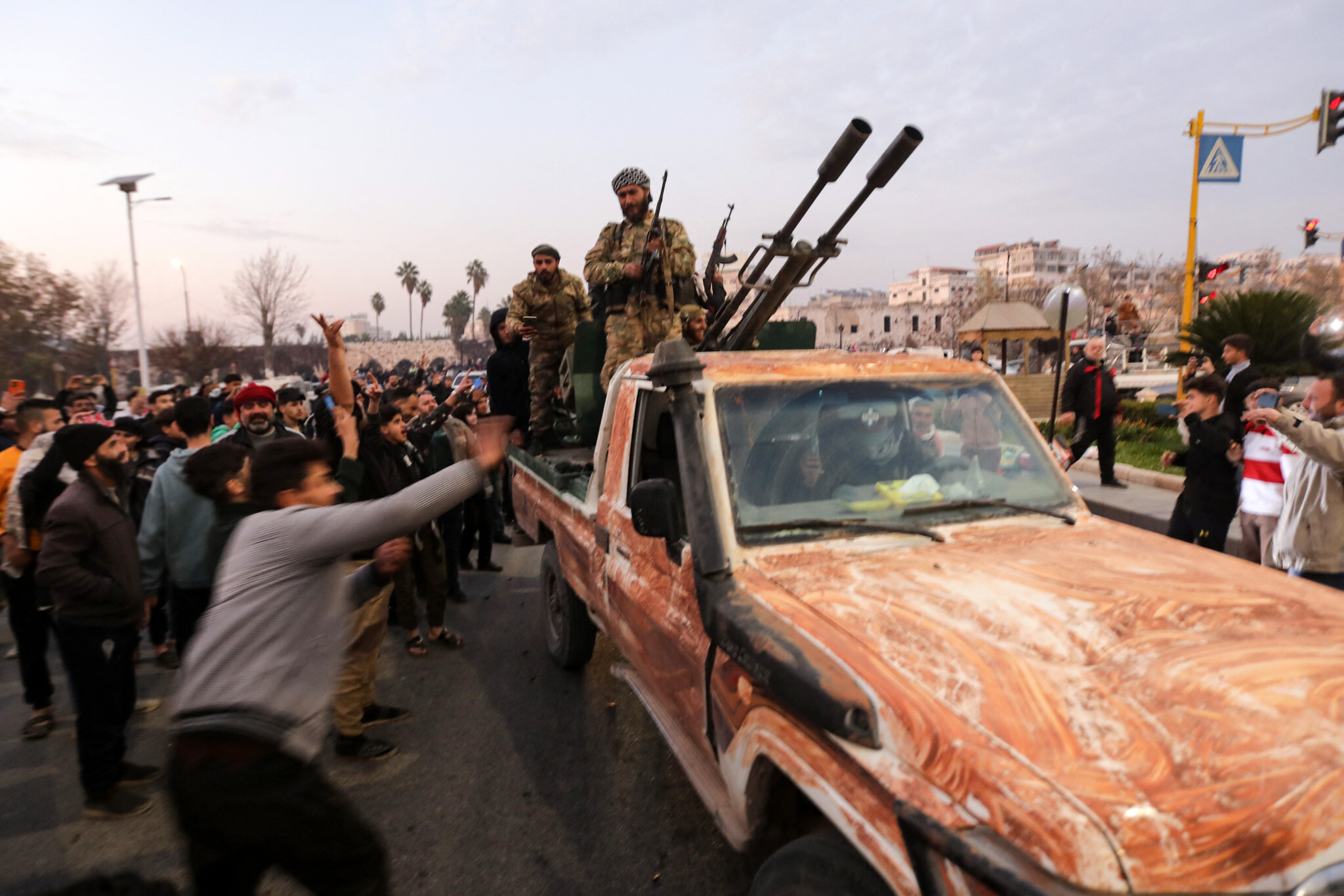 Residents take to the streets of Hama, to welcome anti government fighters after they took control of Syria's west-central city. Photo: AFP