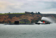 HMS Triumph, the last of the Trafalgar Class submarines still in service has arrived at HMNB Devonport for the last time before her decommissioning. The Boat gracefully transited across Plymouth Sound escorted by tugs boats and following-on craft from the Naval Base, after travelling down from HMNB Clyde submarine base in Scotland, where she had been operating from. HMS Triumph was laid down at Barrow Shipyard in February 1987 and commissioned less than five years later in October 1991, the last of the seven Trafalgar class submarines constructed for the Royal Navy. The current HMS Triumph is the tenth vessel and the second submarine to bear the name. The first Triumph was a 68-gun galleon built in 1561, and was the largest Ship built in England during the reign of Queen Elizabeth the first. A square-rigged galleon of four masts, she served as the flagship of Admiral Frobisher during the battles of the Spanish Amarda.