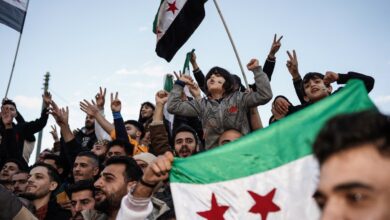 Syrians living in Athens chant slogans as they gather in Syntagma Square to celebrate the overthrow of the 61-year Ba'ath Party rule in Syria with the Syrian opposition's 'revolution flag,' following the collapse of regime control in the capital, Damascus, on Sunday, December 8, 2024, in Greece. (Photo by Nick Paleologos / SOOC / SOOC via AFP)