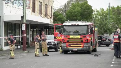 Fire fighters gather at the scene of a fire at the Adass Israel Synagogue in Melbourne on Friday © Tania LEE / AFP