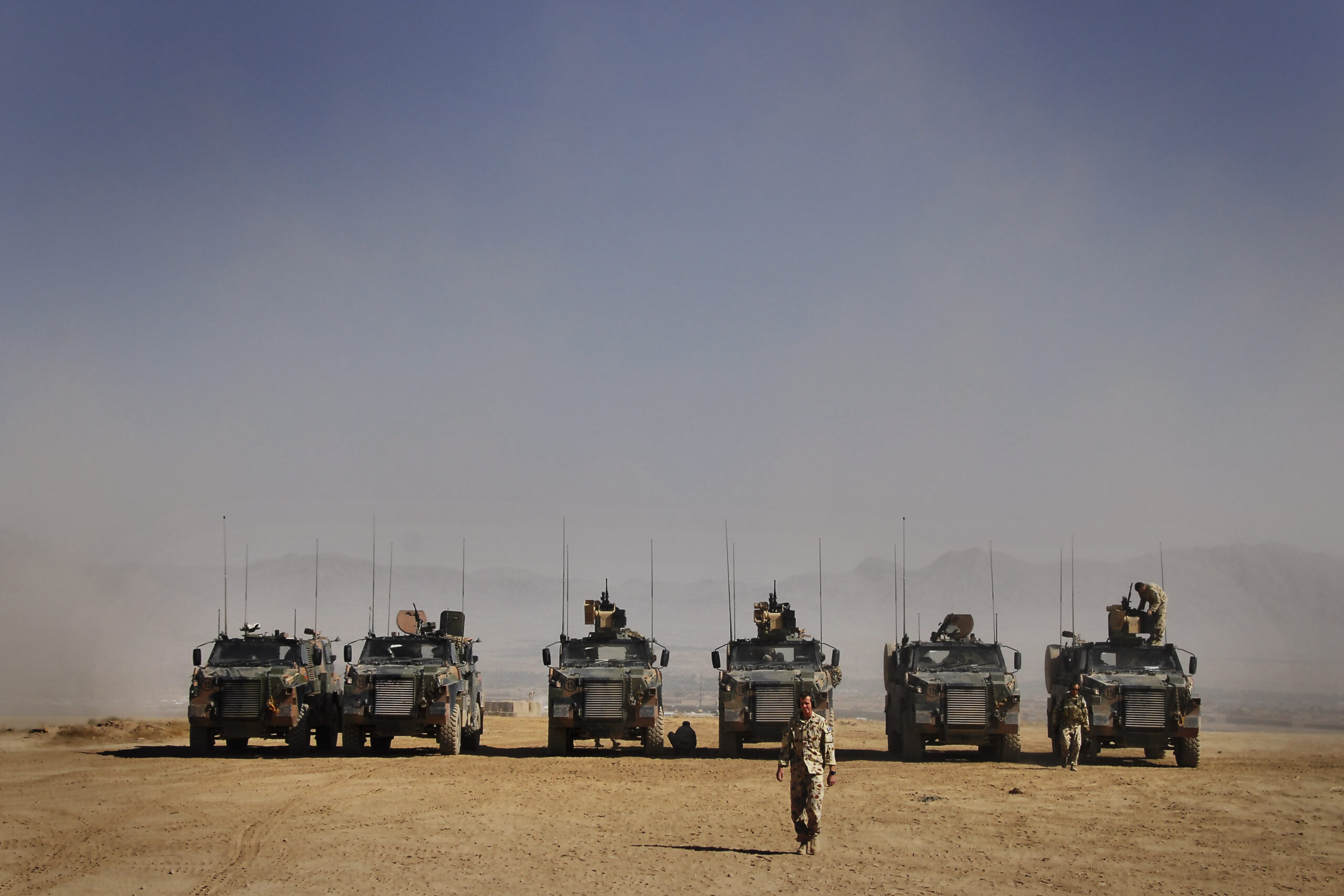 Photographer: Corporal Jamie Osborne Caption: The Bushmaster Infantry Mobility Vehicle at the range in Camp Holland. Title: Range practice in Afghanistan Deep Caption: Soldiers from the Reconstruction Task Force conducted a realistic live fire exercise at Camp Holland, Afghanistan. Soldiers regularly conduct these practices to stay as well trained as they can. Australia has deployed an ADF Reconstruction Task Force (RTF), consisting of a combined arms team, to the Uruzgan Province in southern Afghanistan as part of Operation Slipper. The RTF is in partnership with the Netherlands Provincial Reconstruction Team (PRT) and forms part of the NATO- led International Security Assistance Force. The RTF has a clearly defined role to work on reconstruction, improvement of provincial infrastructure and community based projects. The RTF also provides trade training to the local population and military engineering training to the Afghan National Army. This type of assistance is designed to benefit the people of Uruzgan Province well into the future and form building blocks of a stable and prosperous community. The RTF contains around 370 ADF personnel from predominately Queensland-based units. It includes elements to provide command, security, engineering, and administrative support and is equipped with Bushmaster Infantry Mobility Vehicles (IMV), Australian Light Armoured Vehicles (ASLAVs) and armoured engineer plant equipment. Australia's contribution to ISAF is an important component of the Australian Government's commitment to assist Afghanistan achieve a stable and secure future. *** Local Caption *** Australia has deployed an ADF Reconstruction Task Force (RTF), consisting of a combined arms team, to the Uruzgan Province in Southern Afghanistan as part of Operation Slipper. The RTF is in partnership with the Netherlands Provincial Reconstruction Team (PRT) and forms part of the NATO- led International Security Assistance Force. The RTF has a clearly defined role to work on reconstruction, improvement of provincial infrastructure and community based projects. The RTF also provides trade training to the local population and military engineering training to the Afghan National Army. This type of assistance is designed to benefit the people of Uruzgan Province well into the future and form building blocks of a stable and prosperous community. The RTF contains around 370 ADF personnel from predominately Queensland based units. It includes elements to provide command, security, engineering, and administrative support and is equipped with Bushmaster Infantry Mobility Vehicles (IMV), Australian Light Armoured Vehicles (ASLAVs) and armoured engineer plant equipment. Australia's contribution to ISAF is an important component of the Australian Government's commitment to assist Afghanistan achieve a stable and secure future.