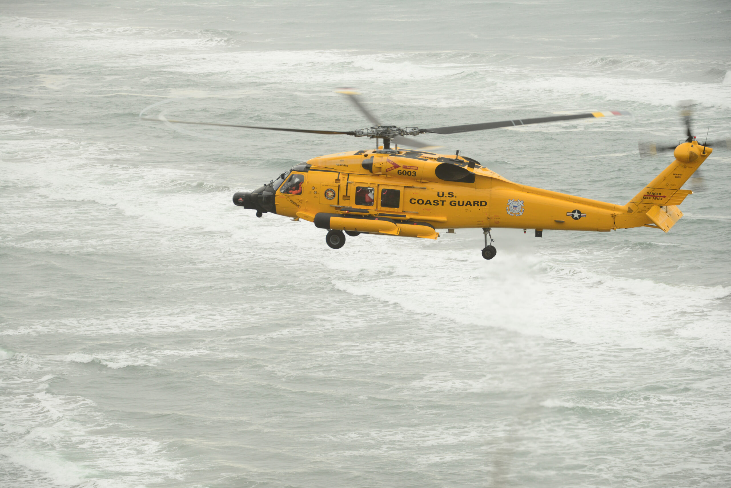 An MH-60 Jayhawk helicopter flies near the North Head Light in Ilwaco, Wash., during a training flight, Nov. 10, 2016. Training is an essential daily activity for aircrews so they can improve their professional proficiency. U.S. Coast Guard photo by Petty Officer 1st Class Levi Read.