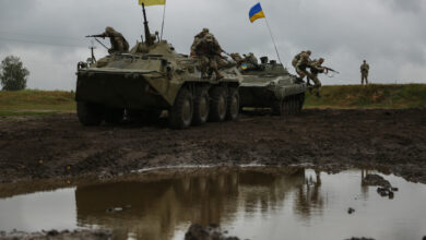 Ukrainian Soldiers of 1st/30th Mechanized Infantry Battalion, role-playing as the opposition force, jump off a BMP-1 and BTR-80 while conducting round robin training during Exercise Rapid Trident 17 at the International Peace Keeping Security Centre in Yavoriv, Ukraine Sept, 12, 2017. Rapid Trident 17 will provide participating nations with the opportunity to improve theatre security cooperation within Eastern Europe, enhance interoperability amongst NATO members and partners, and to combine capabilities to operate joint, multinational and integrated security operations. (U.S. Army photo by Pfc. Zachery Perkins)