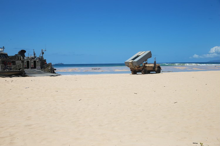 A Landing Craft Air Cushioned (LCAC) assigned to Assault Craft Unit Five (ACU-5) delivers a Navy Marine Expeditionary Ship Interdiction System launcher  to Pacific Missile Range Facility Barking Sands, Hawaii as a part of Large Scale Exercise 2021.