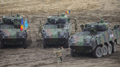 Romanian soldiers assigned to the Black Wolves, 151st Multinational Battle Group ground guide a Piranha V Infantry Fighting Vehicle in a combined arms live fire exercise during Anakonda23 at Nowa Deba, Poland, May 15, 2023. Anakonda23 is Poland's premier national exercise that strives to train, integrate and maintain tactical readiness and increase interoperability in a joint multinational environment, complimenting the 4th Inf. Div.'s mission in Europe, which is to participate in multinational training and exercises across the continent while collaborating with NATO allies and regional security partners to provide combat-credible forces to V Corps, America's Forward deployed corps in Europe. (U.S. Army National Guard photo by Sgt. 1st Class Theresa Gualdarama)