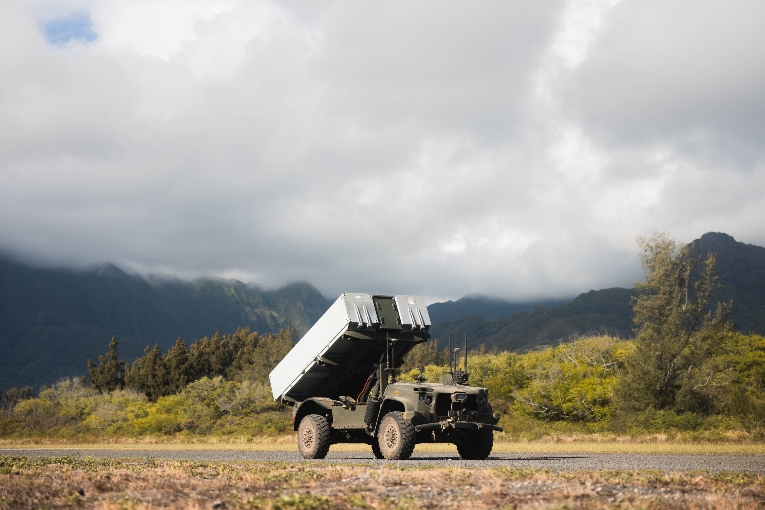 The Navy Marine Expeditionary Ship Interdiction System is placed on a gravel road on Marine Corps Training Area Bellows, Hawaii, Oct. 24, 2024. The NMESIS provides the Marine Corps a highly deployable, land-based, anti-ship system that is a key capability for the Marine Littoral Regiment. (U.S. Marine Corps photo by Cpl. Eric Huynh)