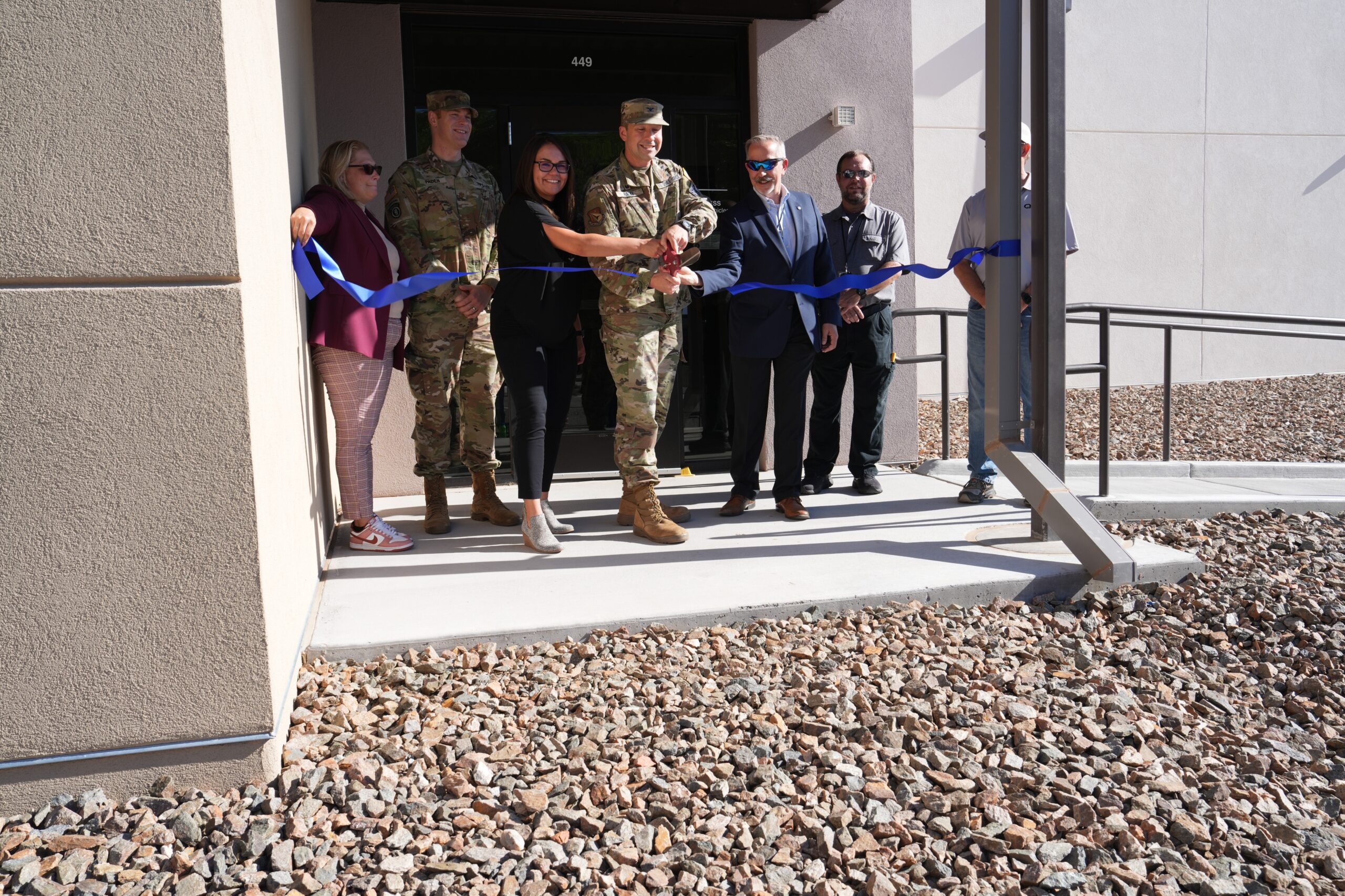 Col. Jeremy Raley, director of the Air Force Research Laboratory’s Space Vehicles Directorate, cuts a ceremonial ribbon in front of the new Radiation Tolerance Research on Electronics for Space and Strategic Systems, or FORTRESS, facility doors Aug. 20, 2024, at Kirtland Air Force Base, N.M. The ceremony commemorated the opening of the new building. FORTRESS will be used for developing new electronic components in space. (U.S. Air Force photo / Paul Robinson)