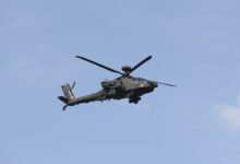 A Boeing AH-64 Apache attack helicopter is flying over the military parade during the National Army Day in Warsaw, Poland, on August 11, 2024.