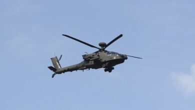 A Boeing AH-64 Apache attack helicopter is flying over the military parade during the National Army Day in Warsaw, Poland, on August 11, 2024.