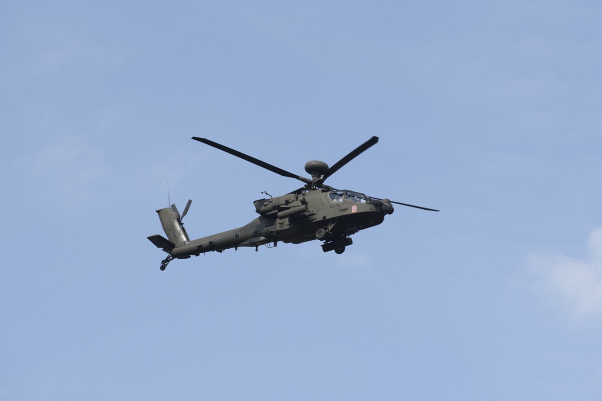 A Boeing AH-64 Apache attack helicopter is flying over the military parade during the National Army Day in Warsaw, Poland, on August 11, 2024.