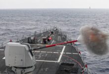 The Arleigh Burke-class guided-missile destroyer USS Rafael Peralta (DDG 115) fires its Mk 45 5-inch gun.