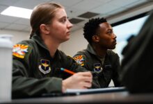 Second Lt. Victoria Cutt and 2nd Lt. Marques Johnson, University of North Dakota Aerospace Foundation student pilots, listen to their instructor, Jan. 7, 2025, in Mesa, Ariz.