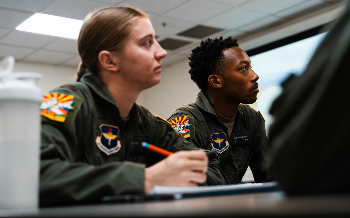 Second Lt. Victoria Cutt and 2nd Lt. Marques Johnson, University of North Dakota Aerospace Foundation student pilots, listen to their instructor, Jan. 7, 2025, in Mesa, Ariz.