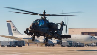 An AH-64D Apache helicopter hovers beside E-8C Joint STARS aircraft prior to departing Robins Air Force Base (AFB), Ga., Jan. 10, 2019. U.S. Army Chief Warrant Officer 2 William Klinger, pilot in command, and Chief Warrant Officer 2 Andrew Williamson, pilot, from the 3rd Infantry Division, 3rd Combat Aviation Brigade, 3/17 Cavalry Regiment, Hunter Army Airfield, Ga., flew the helicopter to Robins AFB to meet with Soldiers and Airmen from Team JSTARS to brief them on the capabilities of the AH-64D Apache and learn more about the capabilities of the E-8C Joint STARS. (U.S. Air National Guard photo by Senior Master Sgt. Roger Parsons)