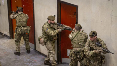 Army reservists prepare to enter a room during an exercise at a new Army training facility. The simulation facility in Scotland creates realistic training for Army reservists. The creation and development of a new Army training facility in Dundee saw Reservists from the 7th Battalion, The Royal Regiment of Scotland (7 SCOTS) train in using simulated ammunition. The new facility, located in Oliver Barracks in Dundee, allows urban operations training. It was constructed and designed for the use of simulation to create a realistic environment for soldiers to enhance their infantry skills in advance of deployments in the UK and overseas. 7 SCOTS, although a light role (Reserve) battalion based in Perth are commanded by 19th Light Brigade who form part of 1st (United Kingdom) Division. Training at weekends highlights the immense level of discipline and commitment by reservists within 7 SCOTS; juggling their civilian routine and employment to participate – gaining and enhancing transferable employable skills. Reservists bring specialist civilian capabilities that are essential both on and off the battlefield, while gaining transferable qualifications by training with the Army. The roles and tasks demanded of the Army Reserve continue to evolve, with more opportunities to enjoy the challenges that come with being a Reservist both in the UK and worldwide.