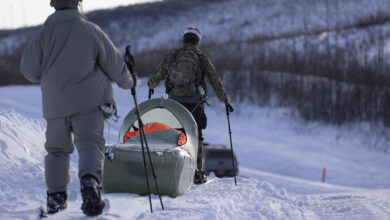 Exercise Special Operations Forces Arctic Medic 2025 participants transport a simulated combat casualty using a CASEVAC Ecosystem sled prototype during Special Forces Arctic Medic 2025 at Yukon Training Area, Alaska, Feb. 18, 2025. SOFAM 2025 prepares medics to operate in arctic or extreme cold environments and to provide safe medical care in a “bubble of warmth” in austere conditions. (Alaska National Guard photo by Seth LaCount)